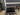 17711 Black Glass and Wood Three-Tier TV Stand